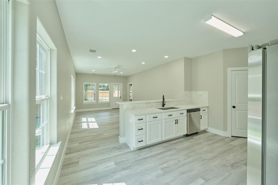 Beautiful neutral paint and flooring and an abundance of windows supply natural light