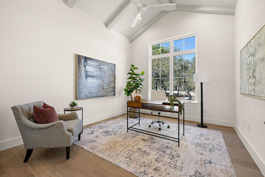 Home office featuring high vaulted ceiling, wood finished floors, a ceiling fan, baseboards, and beamed ceiling