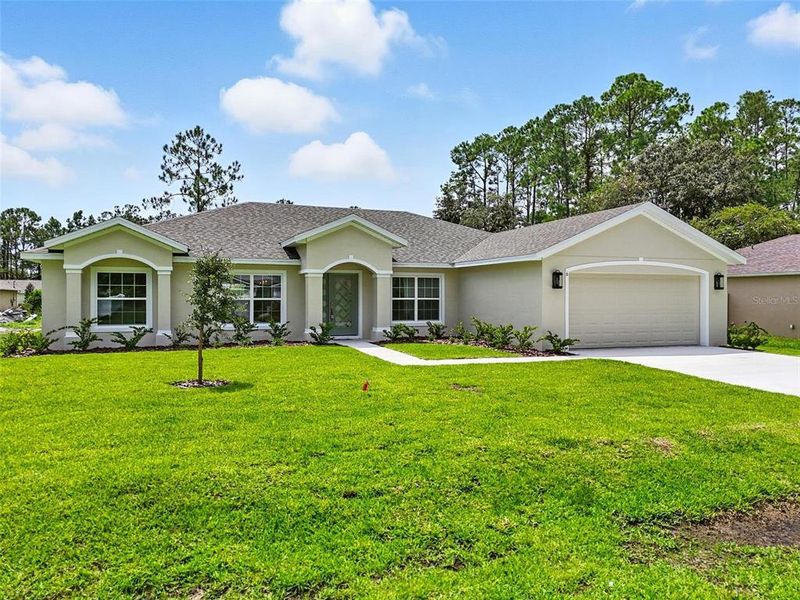 Front exterior of a new home in , Palm Coast, FL, highlighting curb appeal (Image 25).