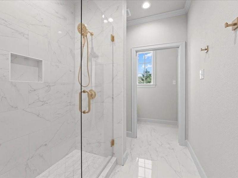 Bathroom with ornamental molding, a marble finish shower, light marble finish flooring, and recessed lighting Bathroom with ornamental molding, a marble finish shower, light marble finish flooring, and recessed lighting