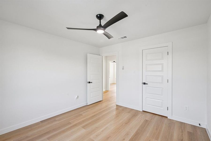 Unfurnished bedroom featuring light wood-style floors and ceiling fan