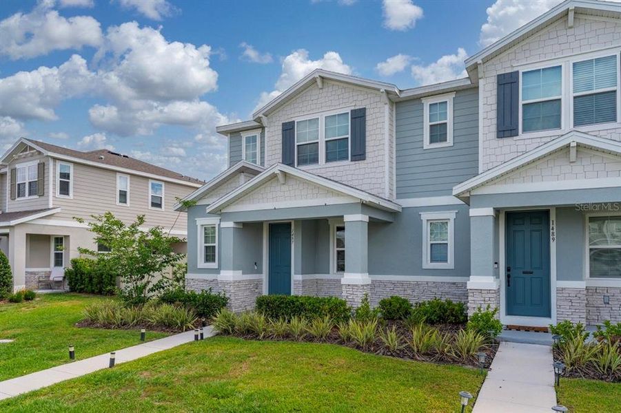 Front exterior of a new home in Urban Collection at Big Sky, Kissimmee, FL, highlighting curb appeal (Image 21).