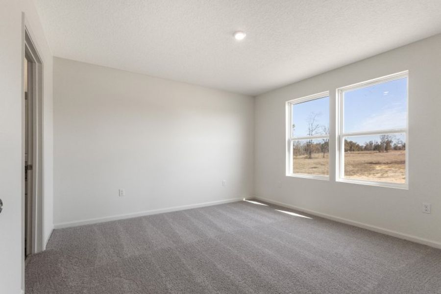 A room with a window and a carpet. A room with a window and a carpet.