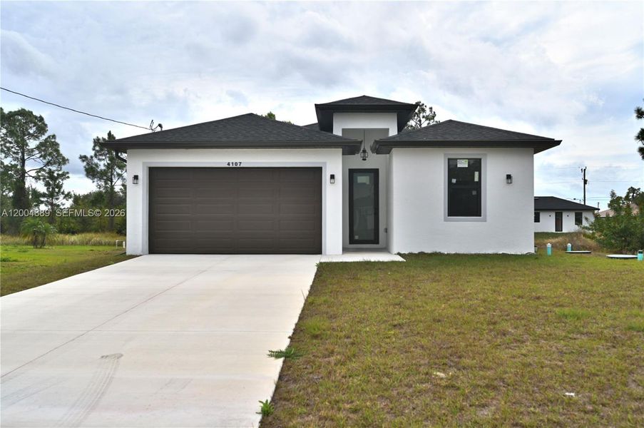 Front exterior of a new home in , Lehigh Acres, FL, highlighting curb appeal (Image 22).