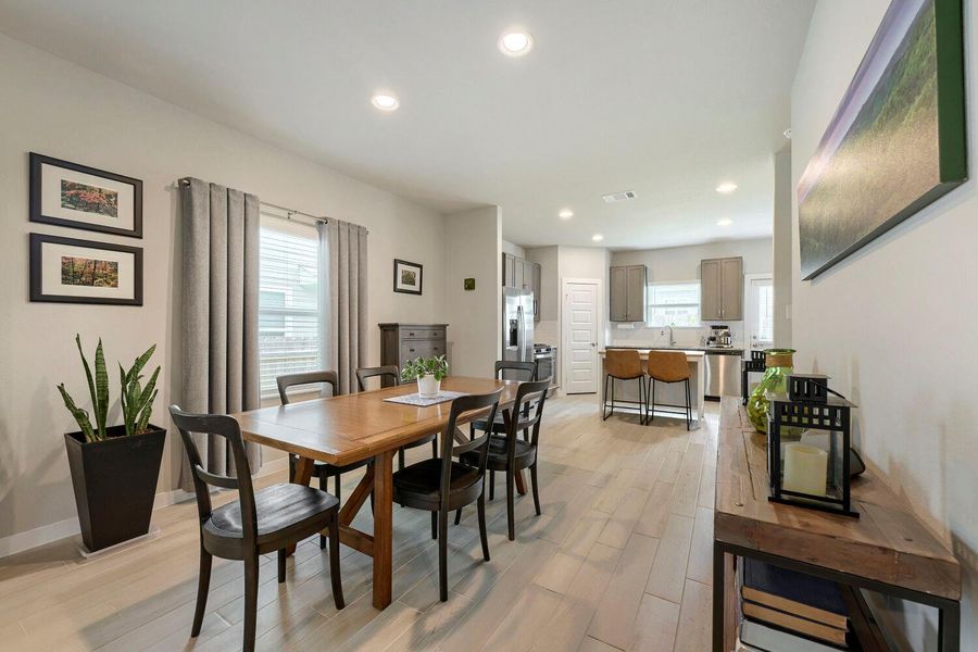 Recessed lighting illuminates this dining area with seamless access to the kitchen, perfect for entertaining. Recessed lighting illuminates this dining area with seamless access to the kitchen, perfect for entertaining.