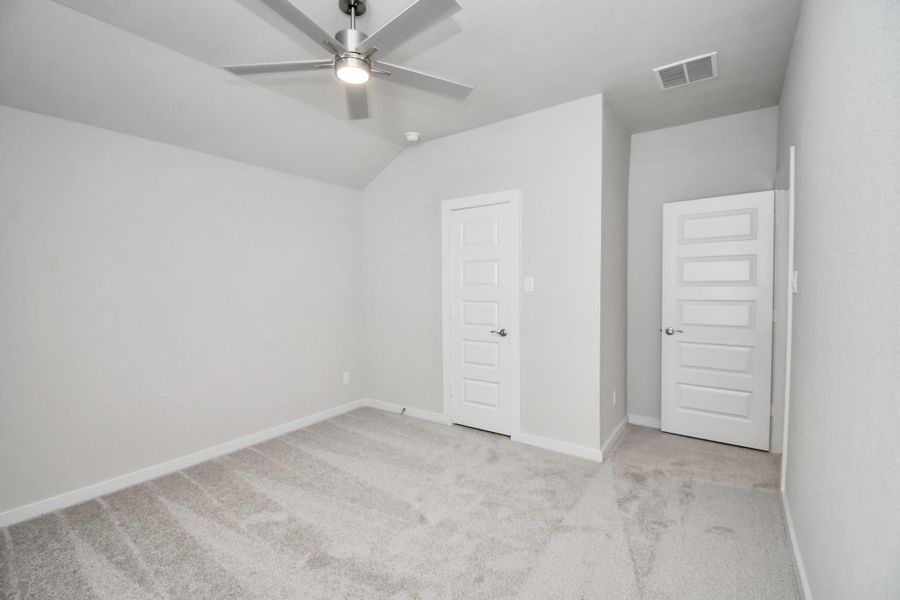 Generously sized secondary bedrooms featuring spacious closets, soft and inviting carpeting underfoot, large windows allowing plenty of natural light, and the added touch of privacy blinds for your personal retreat. Sample photo of completed home with similar floor plan. Actual colors and selections may vary.