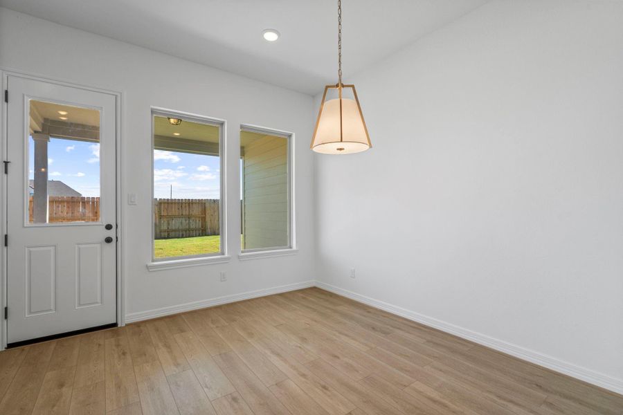 With an abundance of natural light streaming through the windows, the breakfast nook is bathed in a sunny glow, creating the perfect atmosphere to enjoy your morning coffee or a family breakfast.