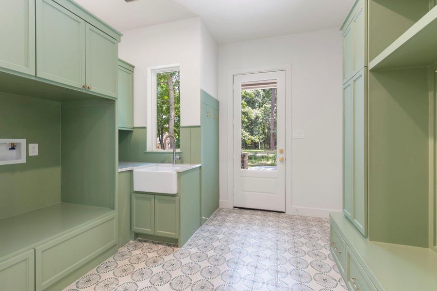 Mud and laundry room off the garage with its own entrance, sink, and plenty of storage. Mud and laundry room off the garage with its own entrance, sink, and plenty of storage.