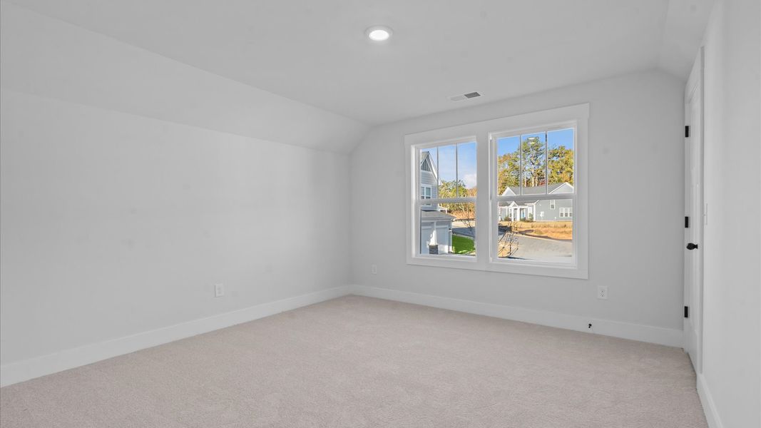 First-rate bedroom with plush carpeting and large windows that provide an open, airy feel