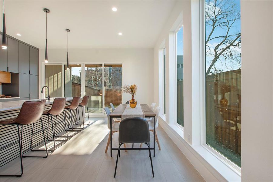 Dining space with light wood-type flooring and sink