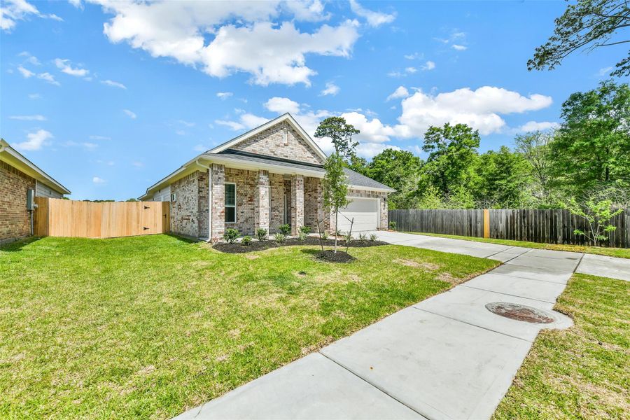 Front exterior of a new home in King Oaks Village, Baytown, TX, highlighting curb appeal (Image 2). Front exterior of a new home in King Oaks Village, Baytown, TX, highlighting curb appeal (Image 2).