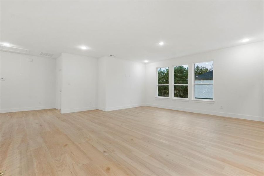 Spare room featuring attic access, light wood-style flooring, and recessed lighting Spare room featuring attic access, light wood-style flooring, and recessed lighting