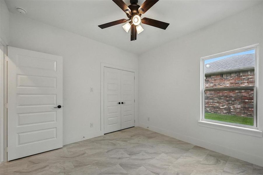 Unfurnished bedroom featuring a closet and ceiling fan