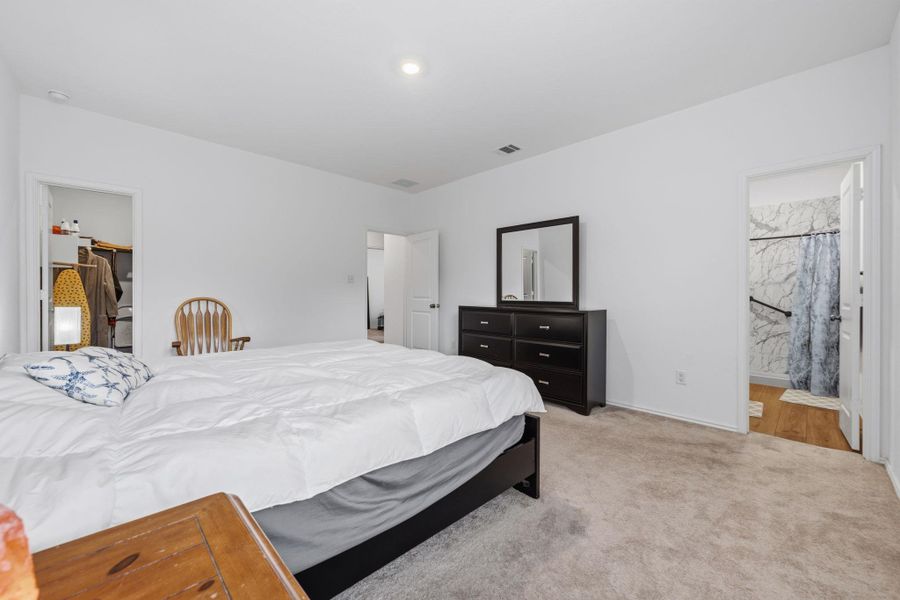 Carpeted bedroom with recessed lighting and white painted walls