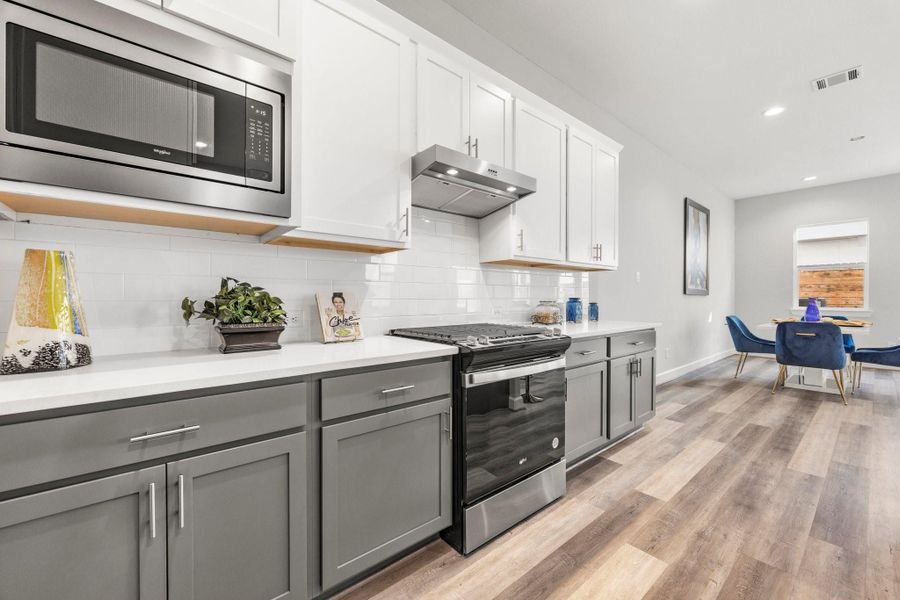 The chef-inspired kitchen featuring sleek finishes, smart storage, and a seamless flow into the main living areas. Image depicts similar floorplan in another ROC Homes community. The chef-inspired kitchen featuring sleek finishes, smart storage, and a seamless flow into the main living areas. Image depicts similar floorplan in another ROC Homes community.