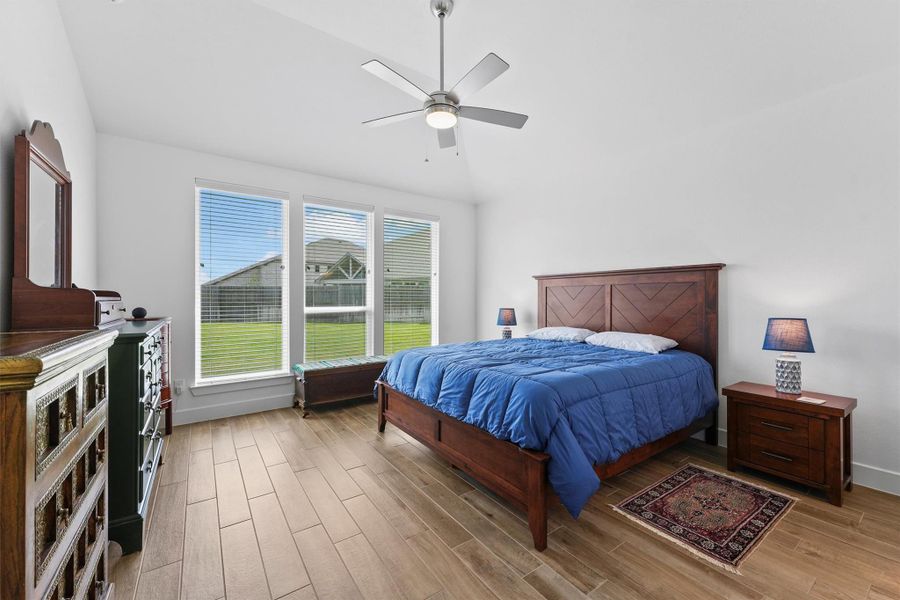 The primary bedroom suite, conveniently located on the first floor, offers a private and tranquil retreat. The room features a great view of the backyard and plenty of natural light.