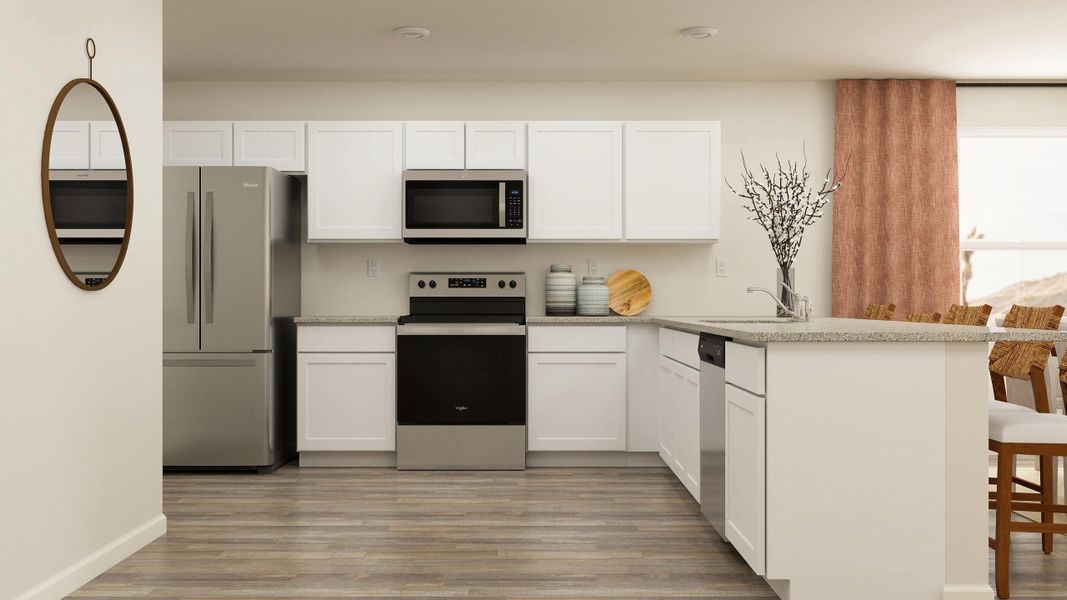 A kitchen with white cabinets.