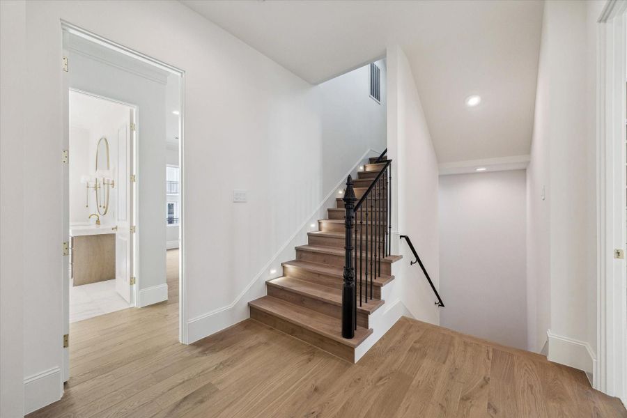 Second floor landing area with stairs and elevator shaft leading to third floor gameroom and final bedroom with en-suite bath.