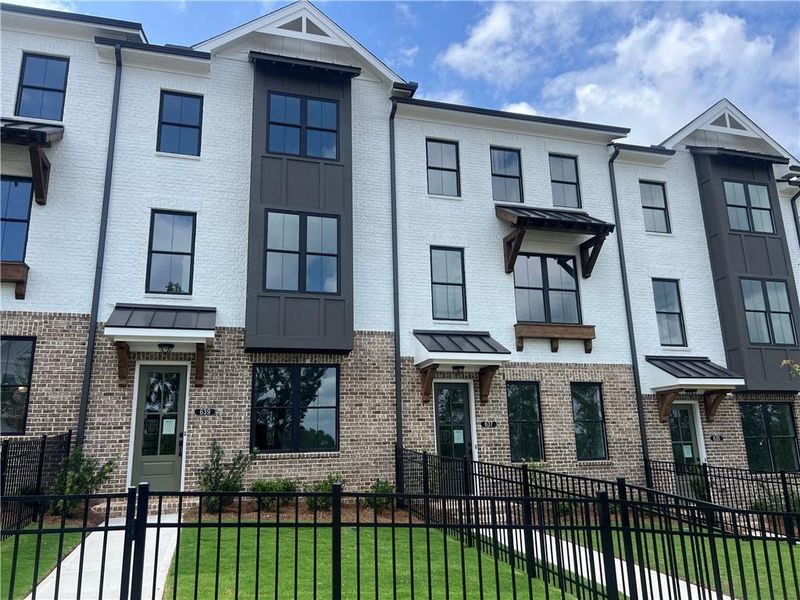 Exterior details and patio area of a home in Palisades Townhomes, Cumming (Image 27).