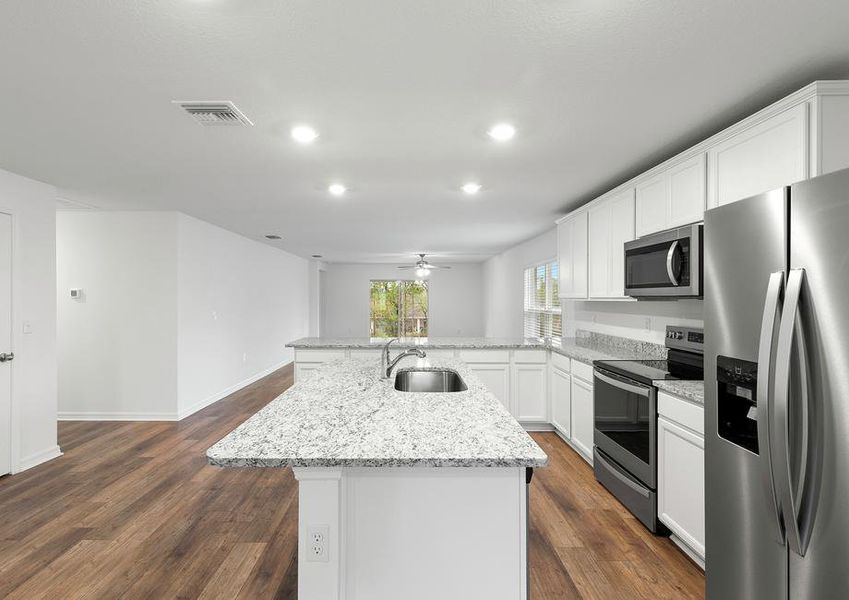 The kitchen is chef-ready with stainless steel appliances