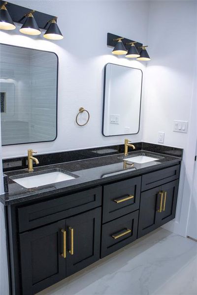 Beautiful double sinks with floating cabinets.