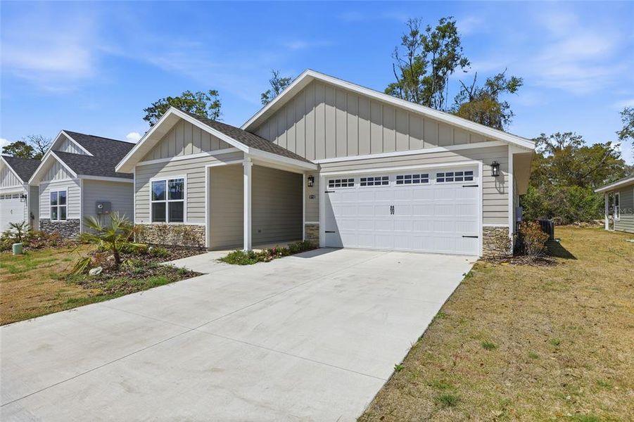 Front exterior of a new home in Grand Oaks, Gainesville, FL, highlighting curb appeal (Image 24).