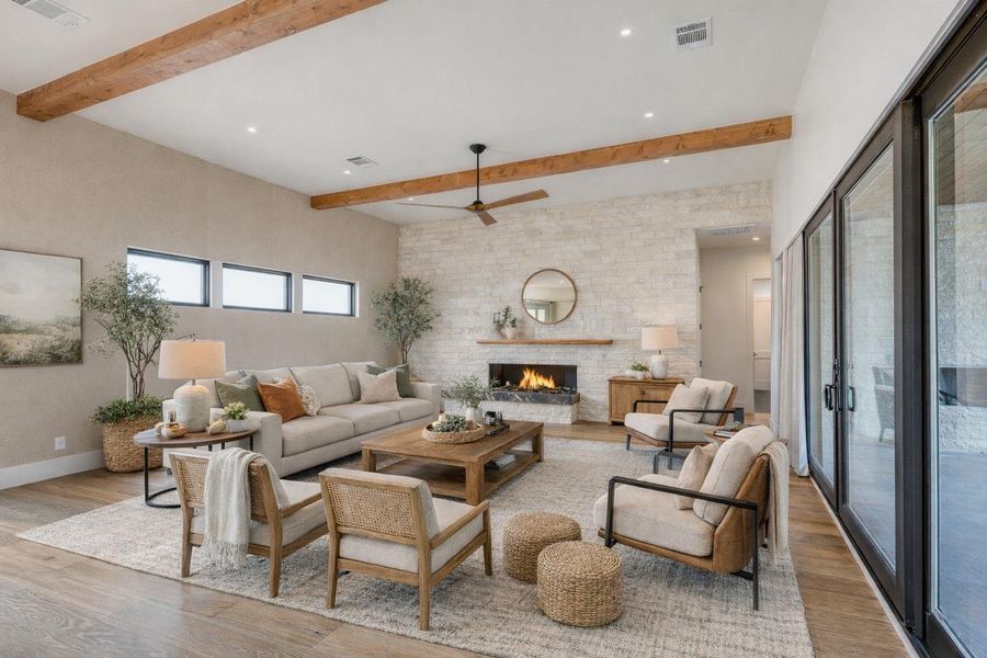Family room (Virtually Staged) open to  kitchen & dining areas and features a 72”linear gas fireplace and floor to ceiling stone wall. Open to spacious outdoor living area and courtyard