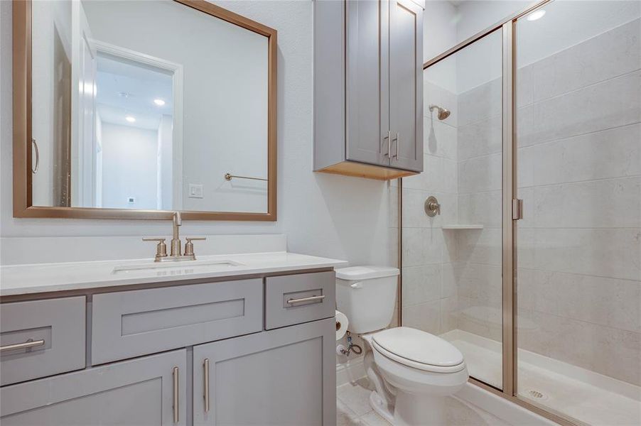 2nd full bath nest to 2nd bedroom features quartz counters and gold fixtures.