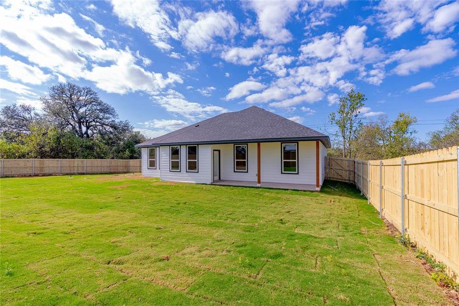 Back of property featuring a yard