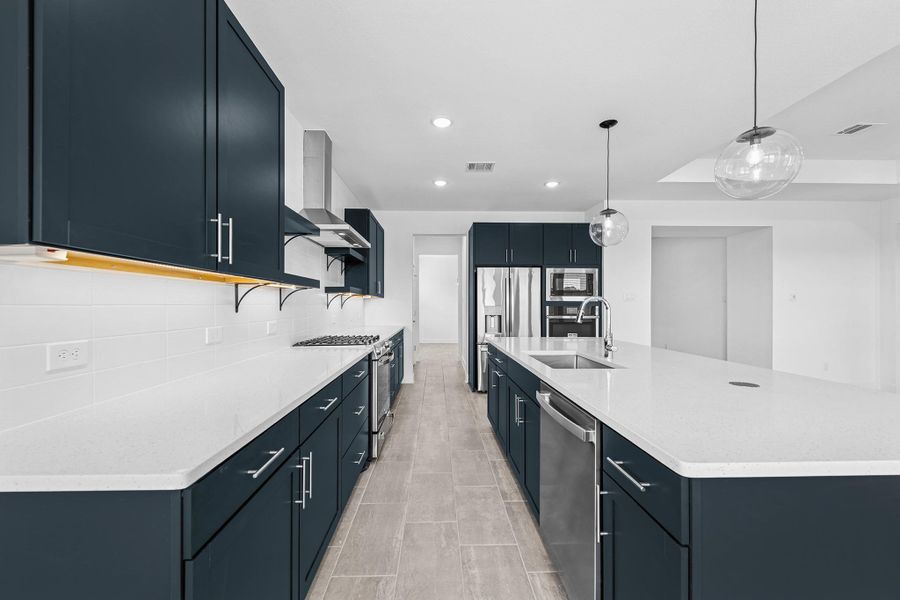 Gorgeous kitchen with blue cabinets and quartz counters