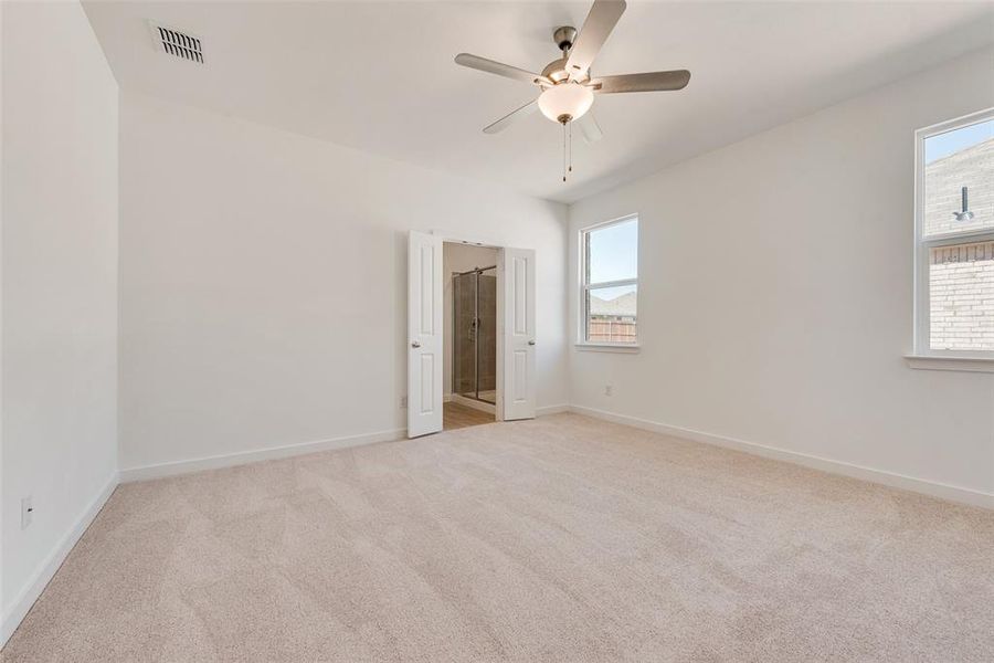 Unfurnished room featuring ceiling fan and light carpet