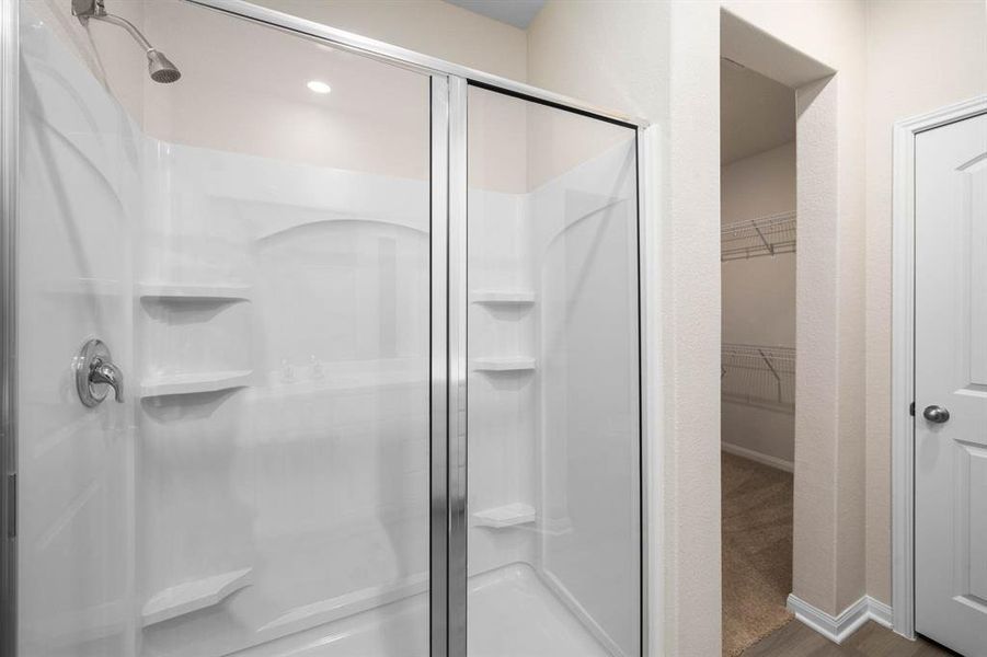 Primary Bathroom includes a tiled walk in shower.