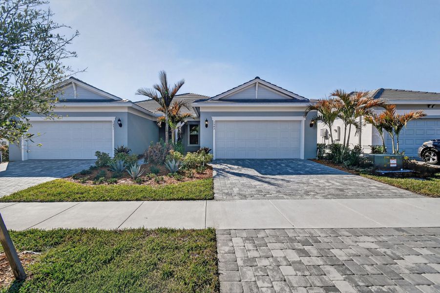 Front exterior of a new home in Costa Pointe, Vero Beach, FL, highlighting curb appeal (Image 27).