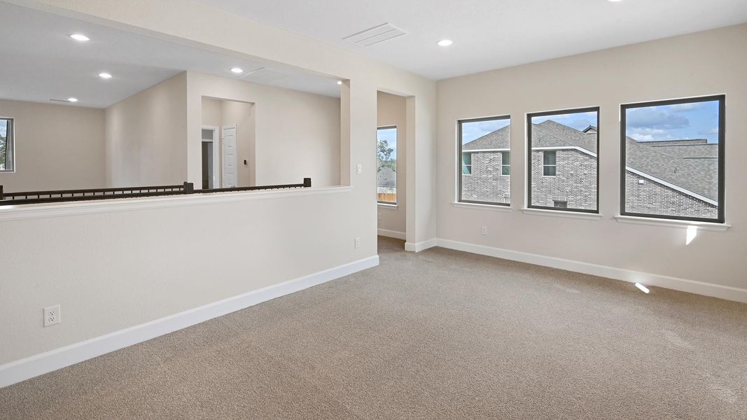 Carpeted empty room featuring baseboards and recessed lighting