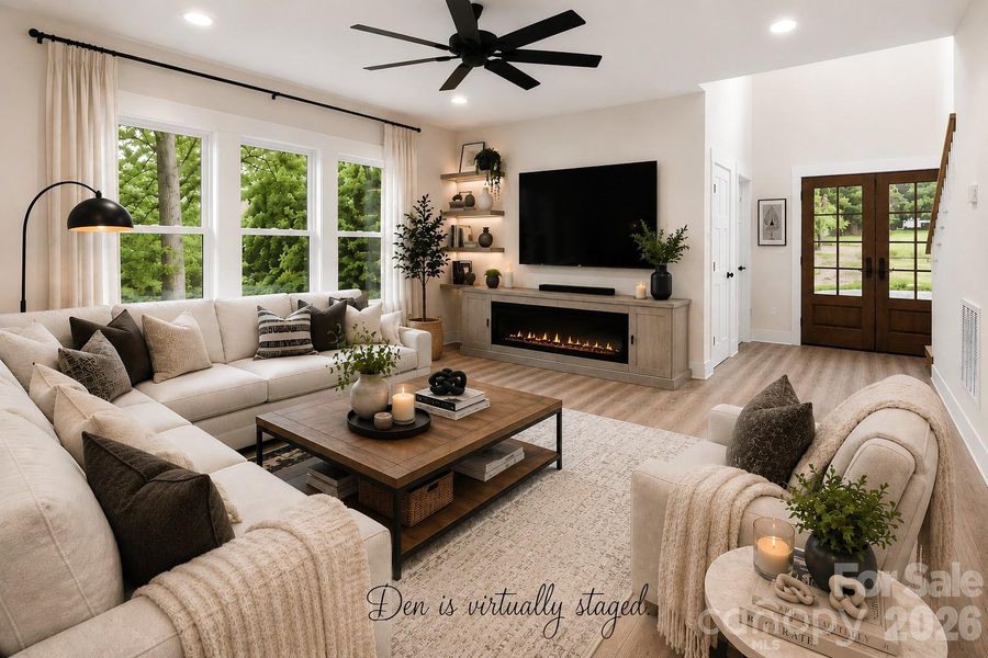Den with LVP wood floors & lots of natural light. (Virtually staged.)