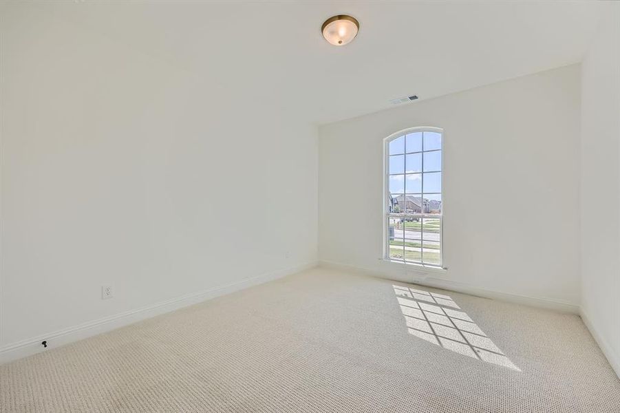 Unfurnished room with light colored carpet