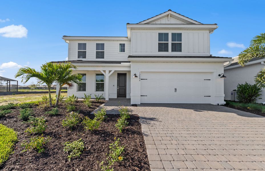 Front exterior of a new home in TerraWalk at Babcock Ranch, Alva, FL, highlighting curb appeal (Image 1). Front exterior of a new home in TerraWalk at Babcock Ranch, Alva, FL, highlighting curb appeal (Image 1).