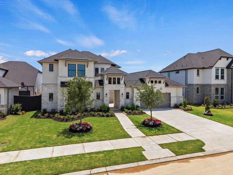 Front exterior of a new home in Harvest Green, Richmond, TX, highlighting curb appeal (Image 21). Front exterior of a new home in Harvest Green, Richmond, TX, highlighting curb appeal (Image 21).