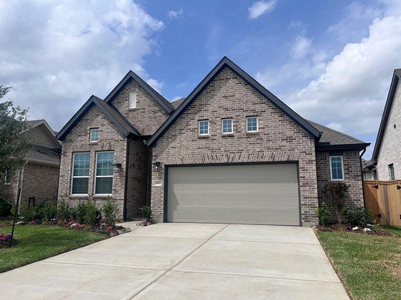 Front exterior of a new home in Wood Leaf Reserve, Tomball, TX, highlighting curb appeal (Image 15).