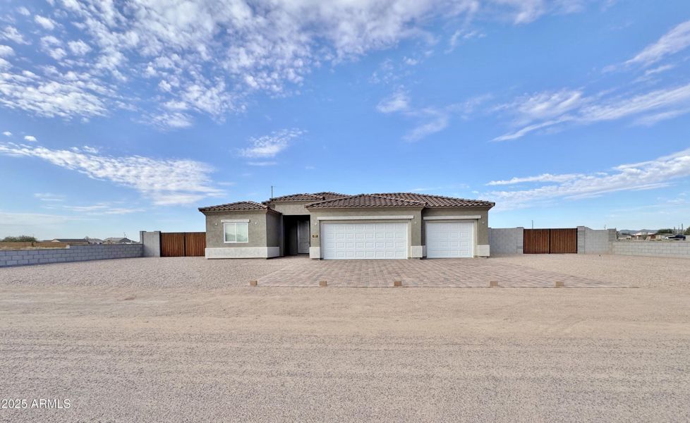 Front of home with 2 RV gates Front of home with 2 RV gates