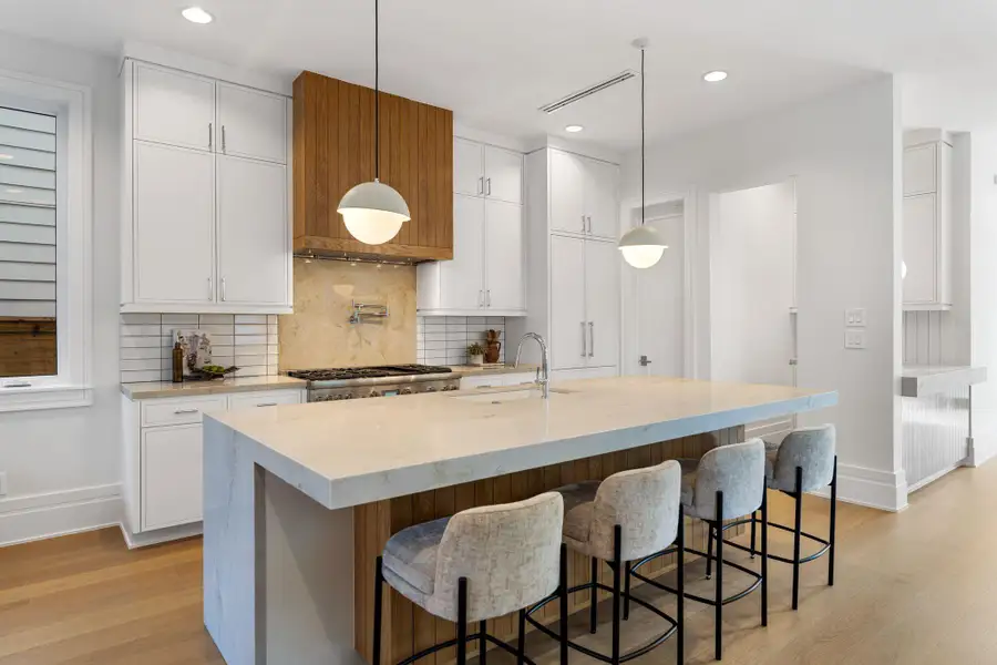 Note the Thermador appliance package with panel front refrigerator. Nicely sized walk-in pantry.