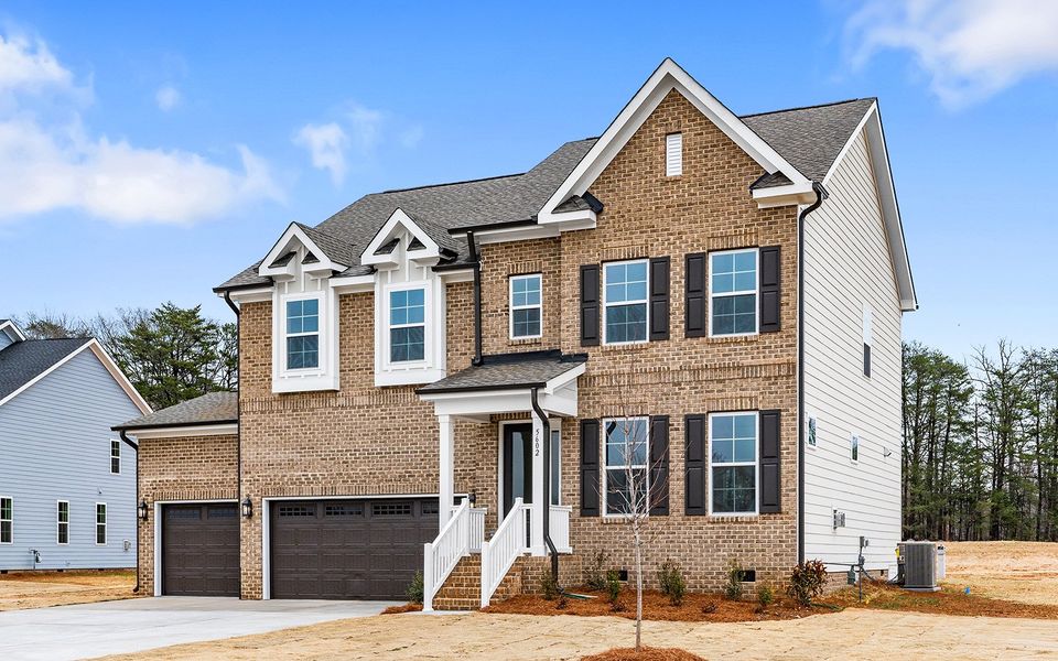 Front exterior of a new home in Lilah Grove, Summerfield, NC, highlighting curb appeal (Image 2). Front exterior of a new home in Lilah Grove, Summerfield, NC, highlighting curb appeal (Image 2).