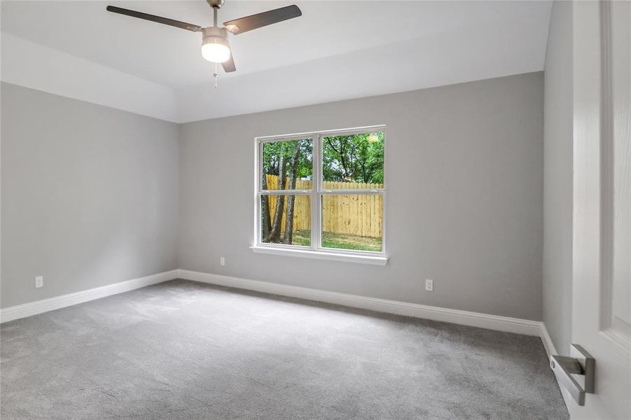 Unfurnished room featuring carpet flooring and ceiling fan