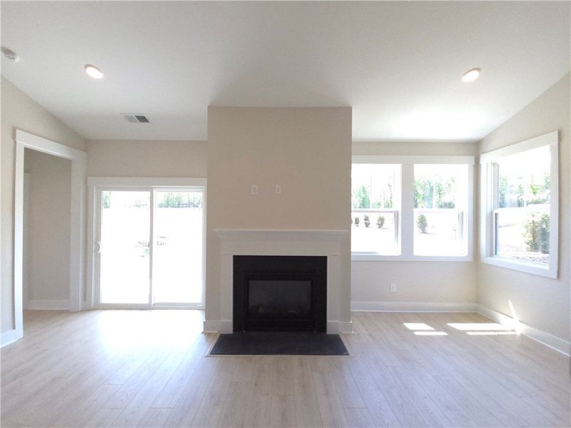 This bright living space features a cozy fireplace