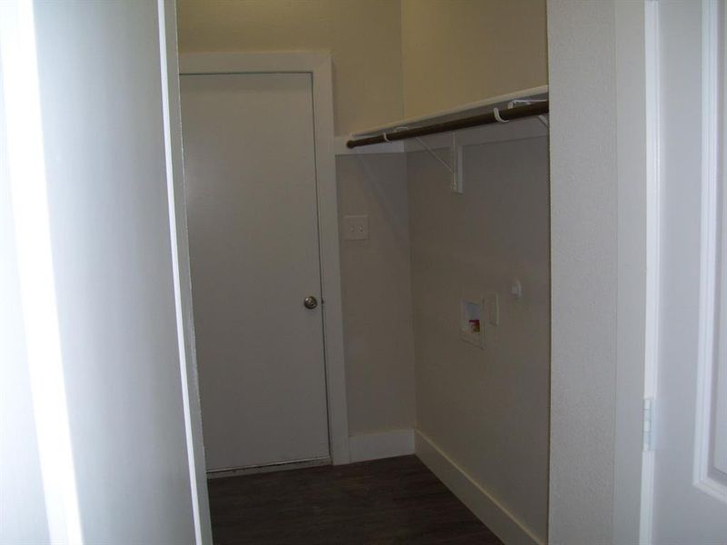 Laundry room featuring hookup for a washing machine and dark wood-style flooring