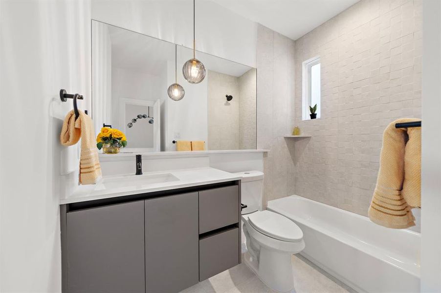 This spacious secondary bathroom on the third floor features modern fixtures, a sleek vanity, and a shower-tub combo, offering both style and convenience for family or guests