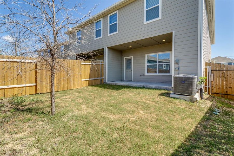 Back of house with a patio, central AC unit, and a yard