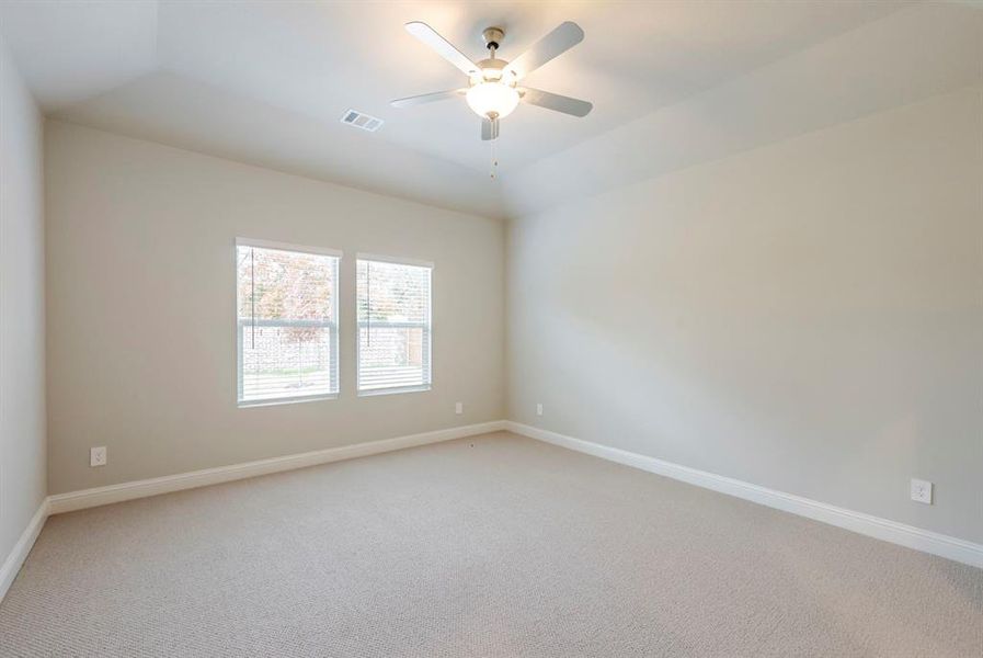 Unfurnished room featuring carpet, vaulted ceiling, and a ceiling fan Unfurnished room featuring carpet, vaulted ceiling, and a ceiling fan
