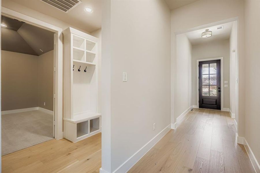 Mudroom featuring light wood finished floors and recessed lighting