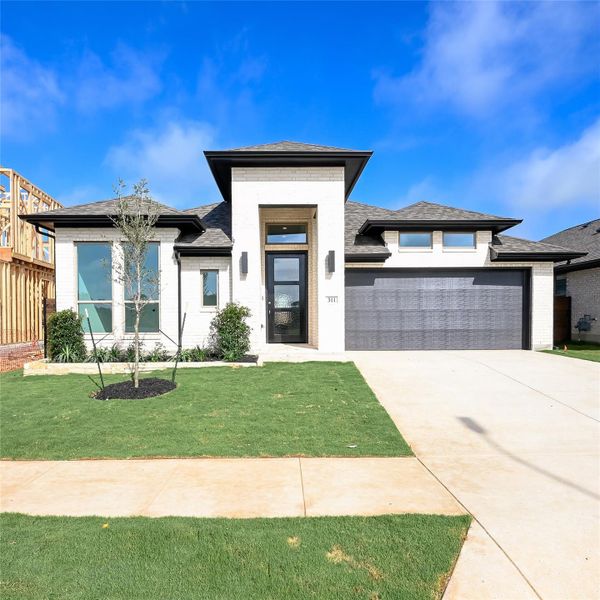 Front exterior of a new home in Juniper Springs, Lockhart, TX, highlighting curb appeal (Image 2). Front exterior of a new home in Juniper Springs, Lockhart, TX, highlighting curb appeal (Image 2).